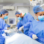 surgeons performing surgery. Doctors are monitoring patient in operating room. They are in hospital.