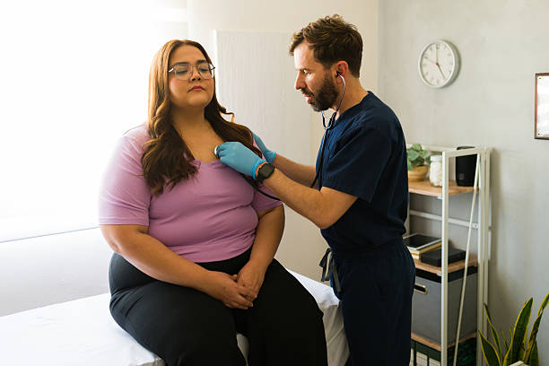 Medical professional listening to patient's breathing, performing routine chest examination in clinical setting, checking health status